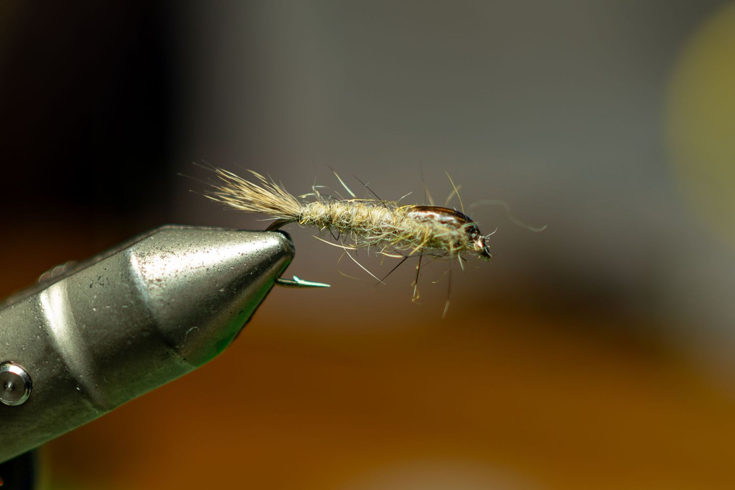Detailed macro shot of a fly fishing lure with delicate hair-like fibers.