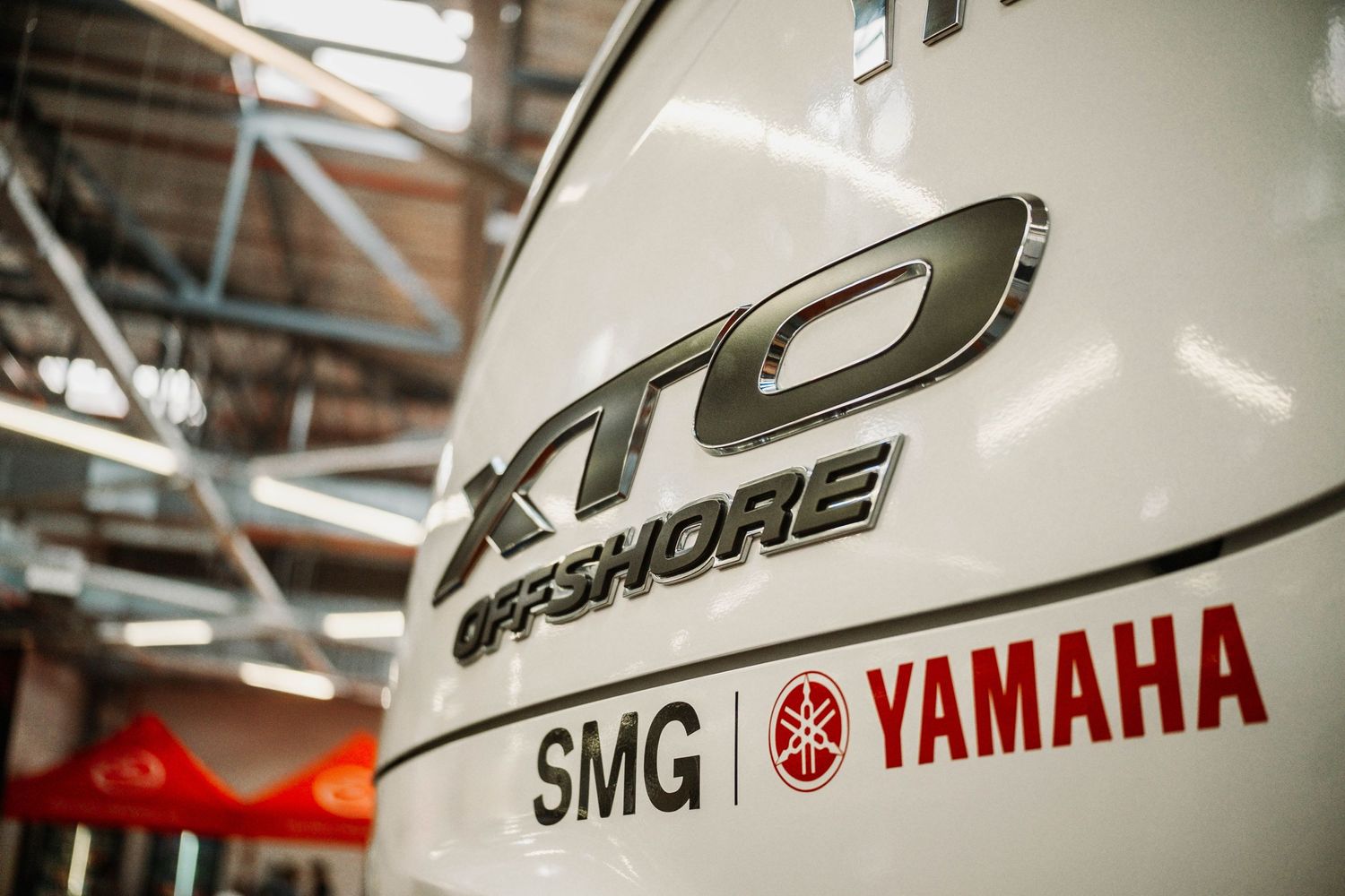 Close-up detail of a Yamaha XTO offshore motor logo on a white surface.