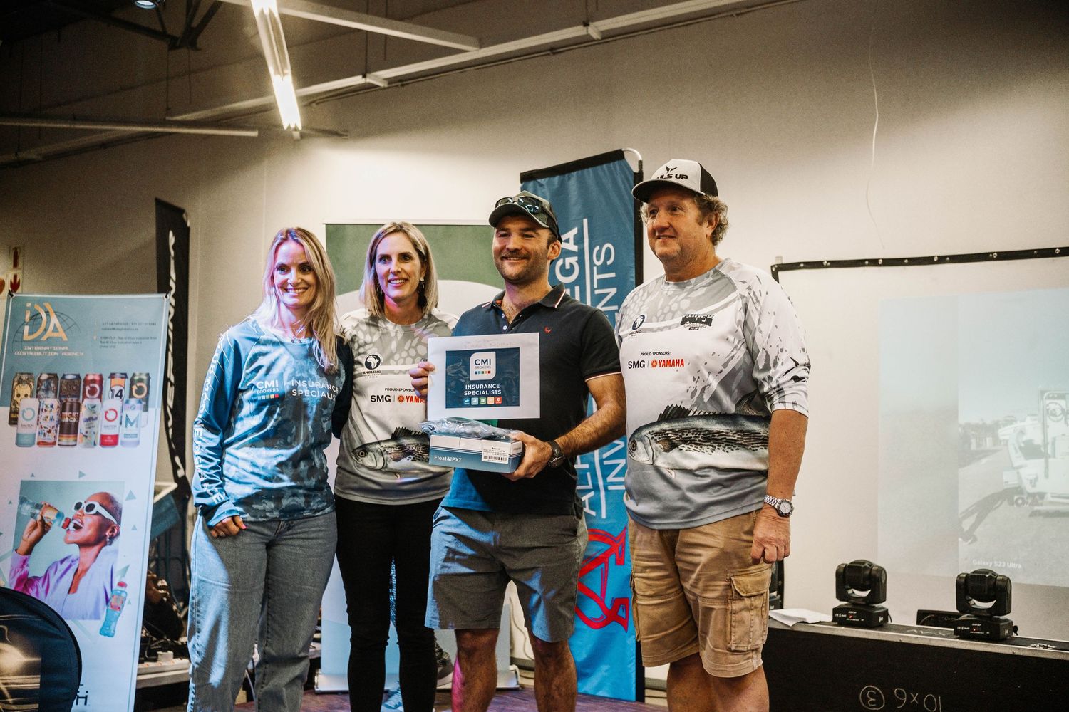 Award presentation ceremony at fishing tournament with winners displaying plaque.