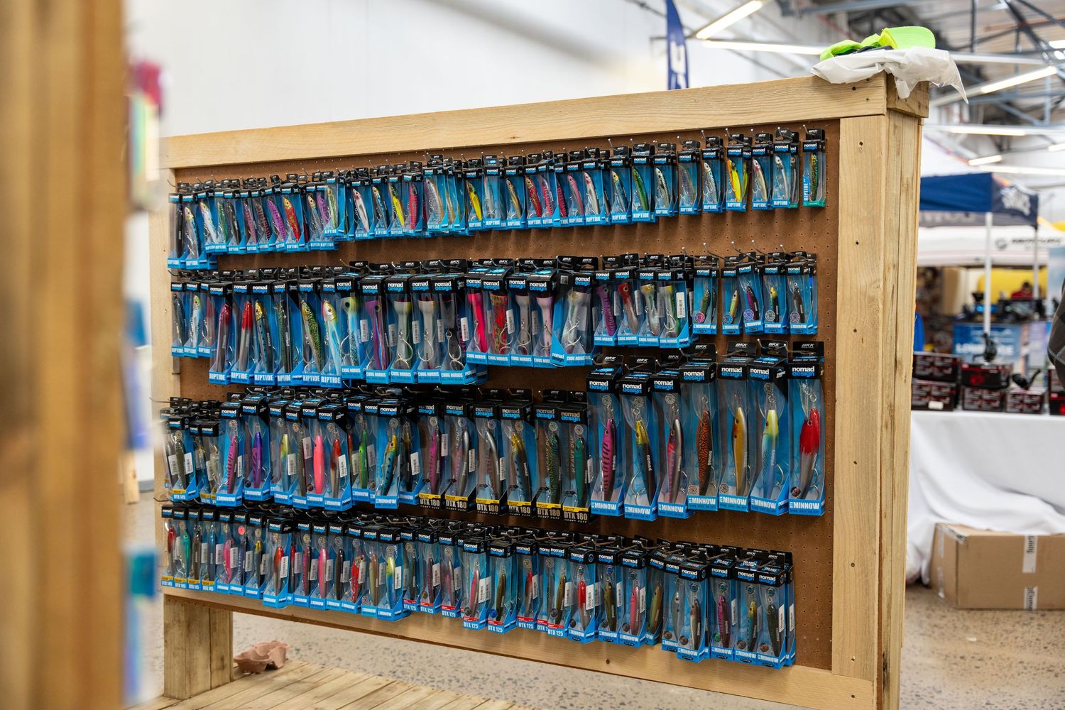 Wooden display shelf filled with rows of bright blue merchandise.