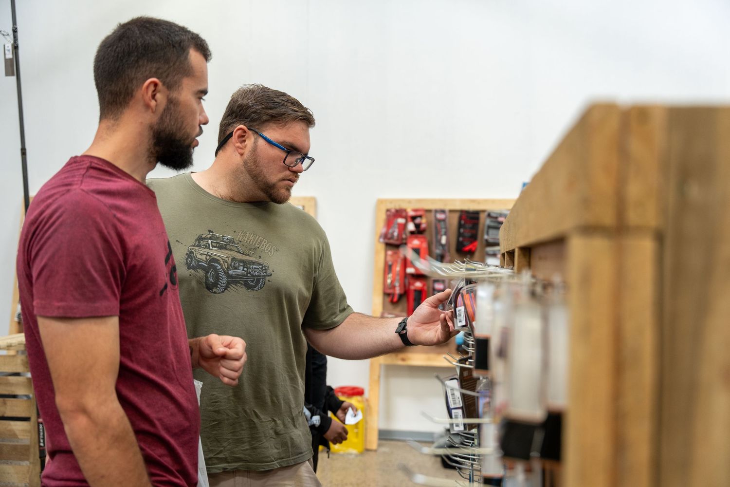 People browsing merchandise at a retail event display.