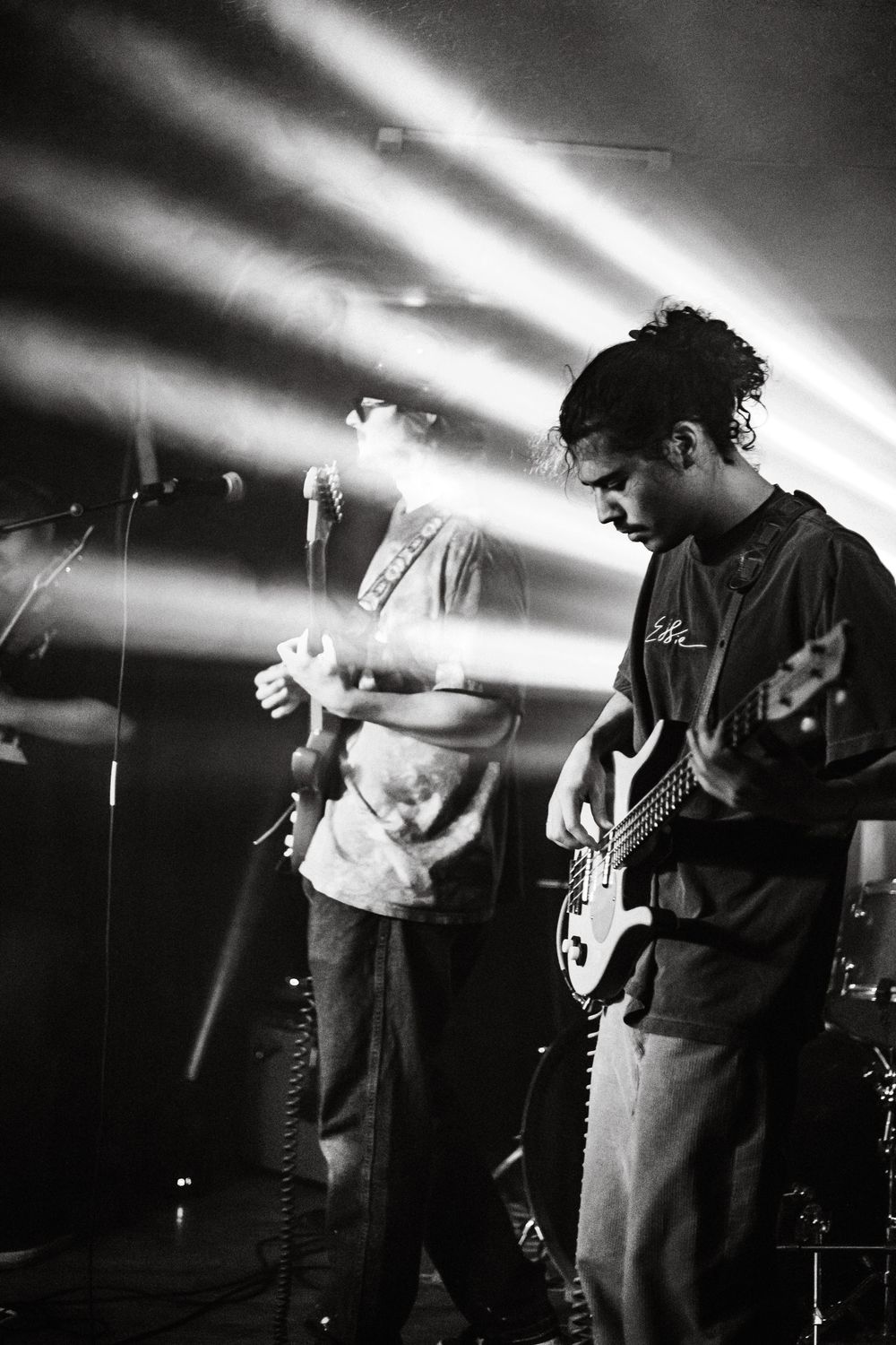 Black and white concert photos show musicians performing energetically on stage with dramatic lighting effects.