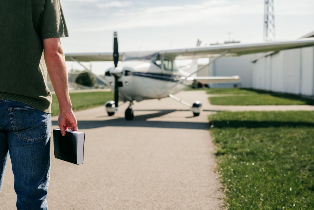 With bible in front of plane