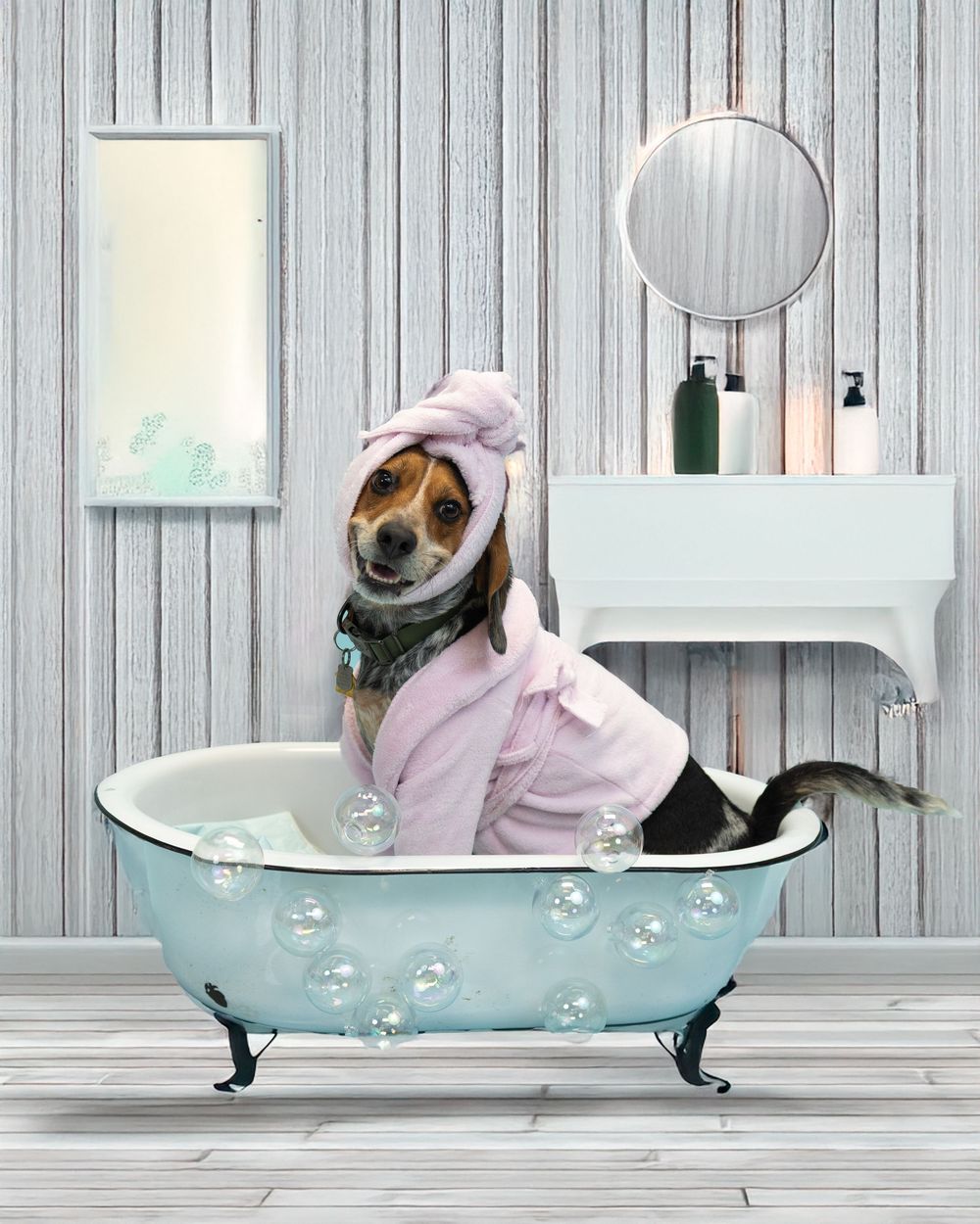 A beagle wearing a pink robe and towel relaxes in a vintage clawfoot bathtub in a spa-like bathroom setting.
