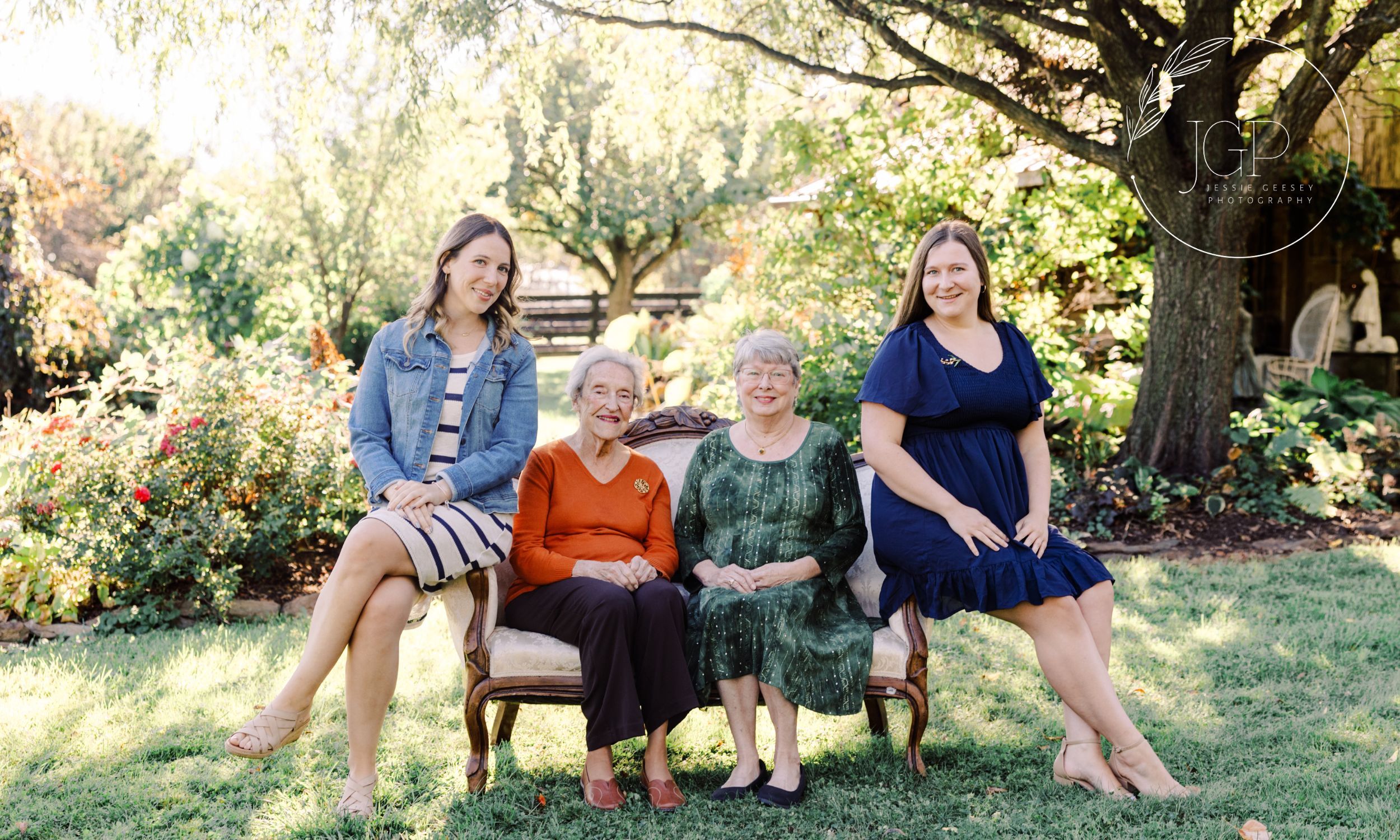 Four women sitting on a couch with a spring and sunny background