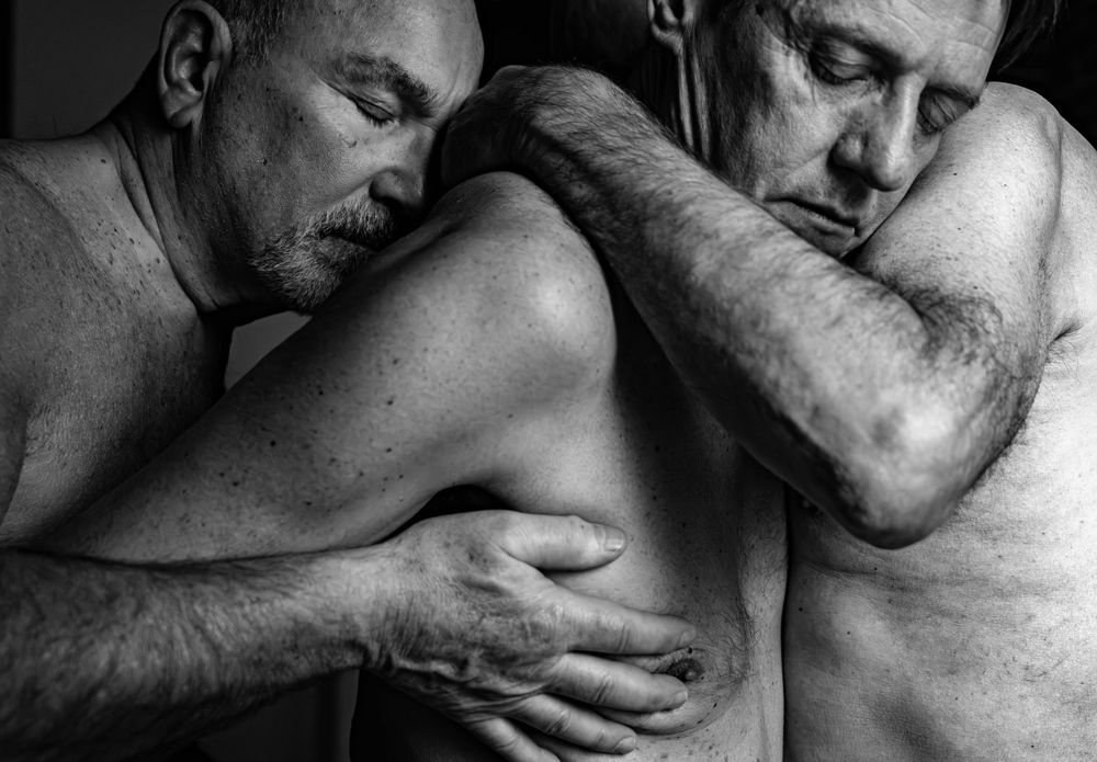 A series of intimate black and white photographs showing close physical affection and tender embraces between two people.