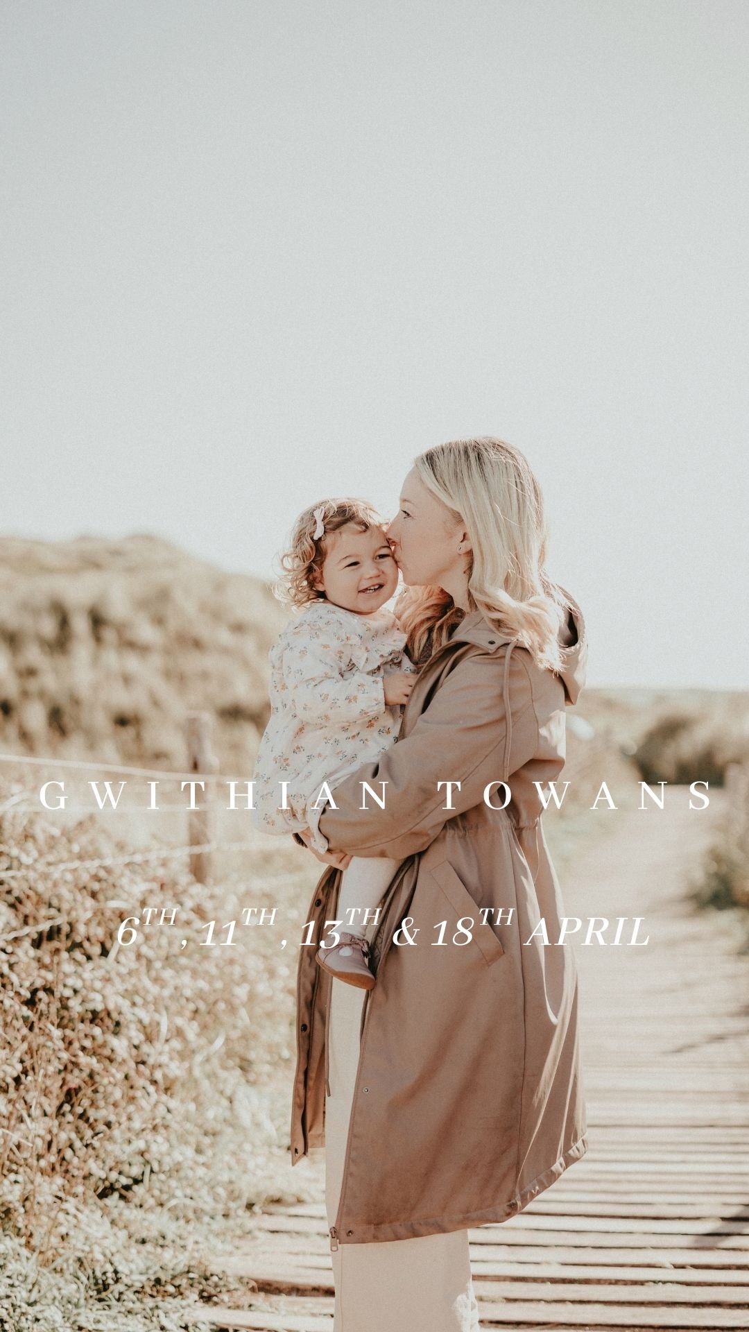 A mother and child share a tender moment on a wooden walkway against a natural landscape in warm sepia tones.