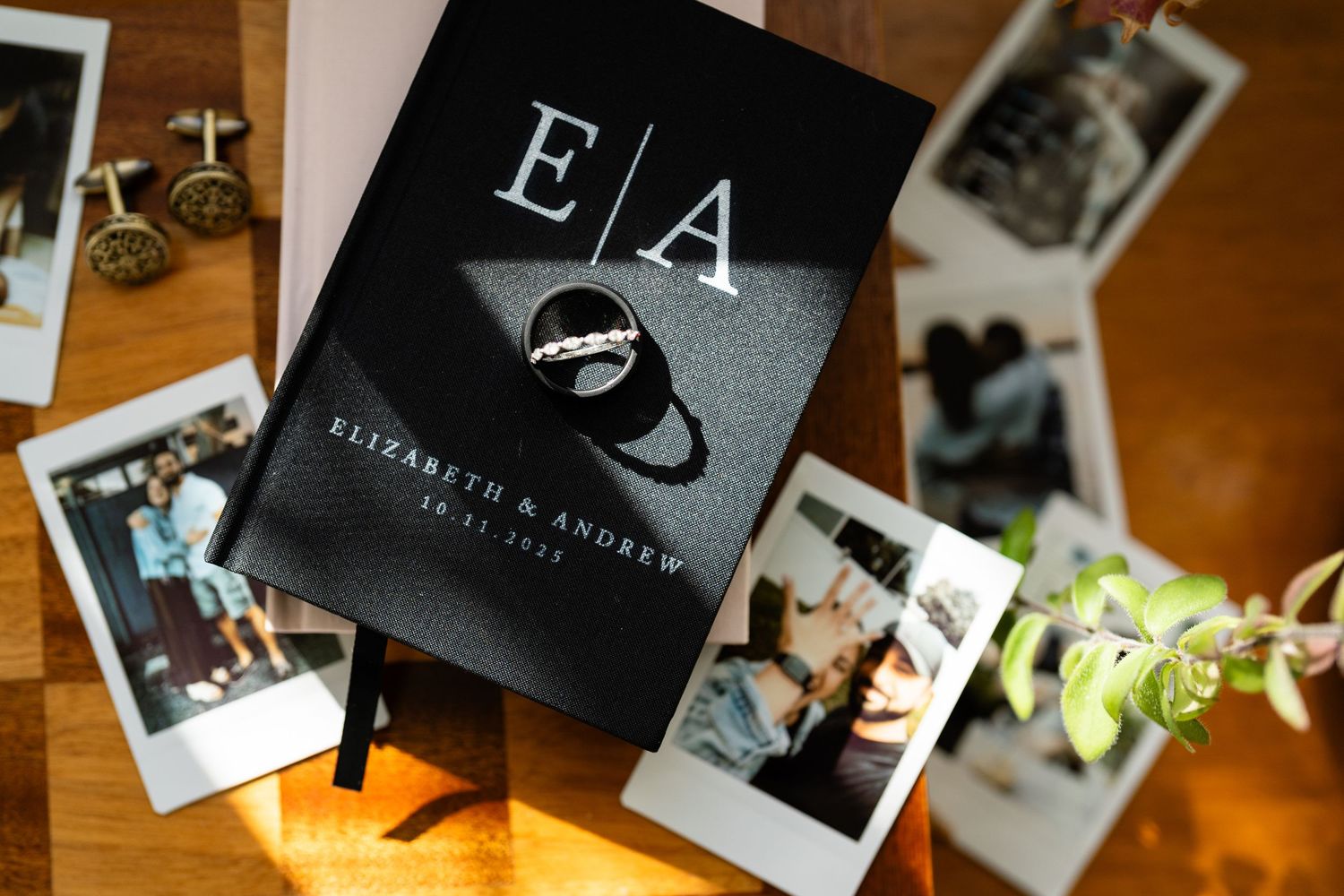 Wedding album and polaroid photos displayed on wooden surface.