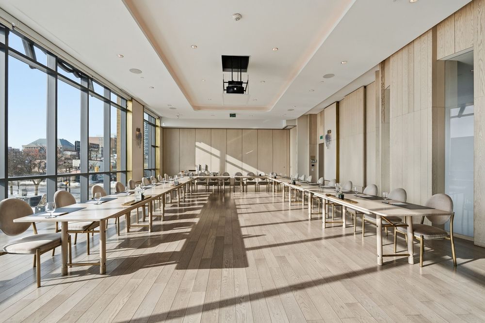 Spacious commercial office space with sleek wooden floors, recessed lighting, and floor-to-ceiling windows.