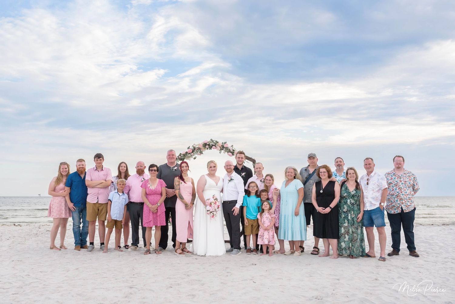 Extended family gathered together during a beautiful Dauphin Island beach wedding ceremony with soft coastal light, ocean views.