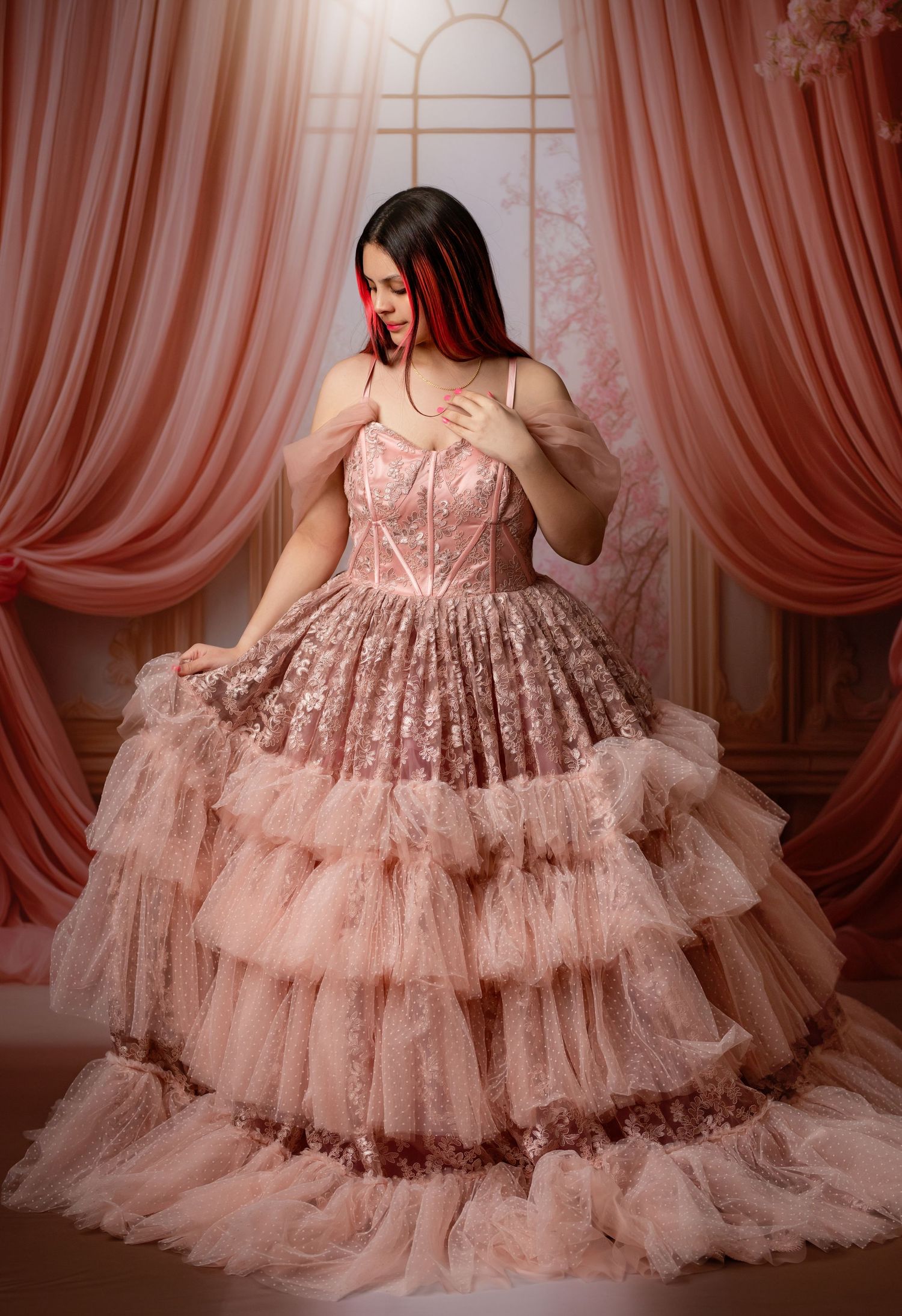 A luxurious burgundy sequined ballgown photographed against a warm brown textured backdrop.