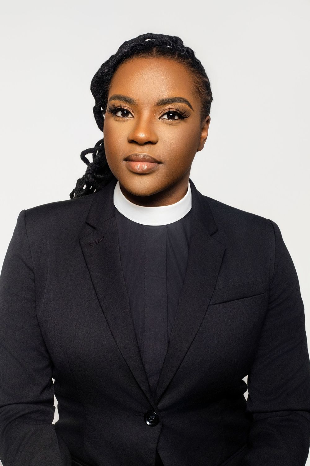 Portrait series showing someone in religious attire with clerical collar against white backdrop.