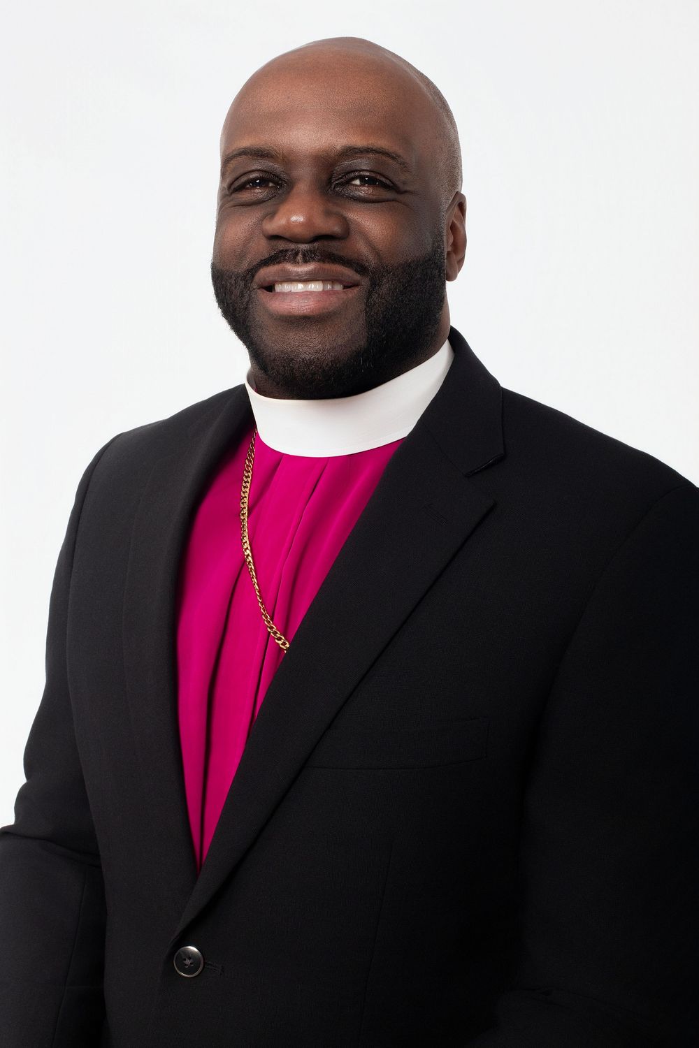 Formal portraits showing someone in clerical attire with black suit and magenta shirt.