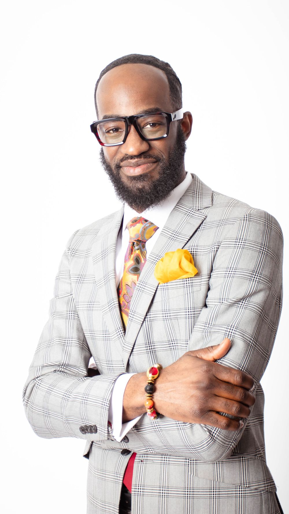 Professional portraits in light gray windowpane suit with yellow tie and pocket square.