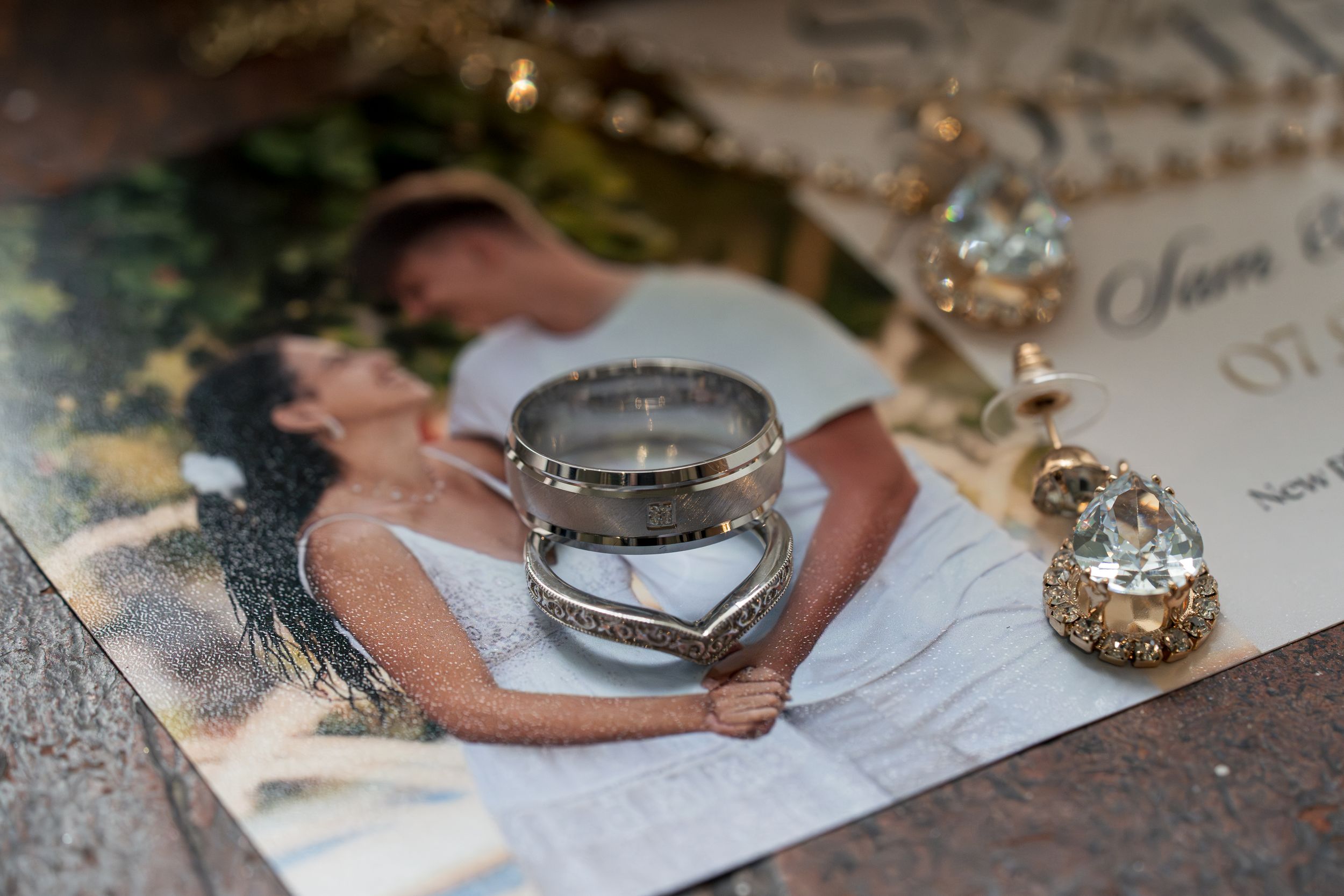Close-up details of wedding table settings with silver plates and crystal decorations.