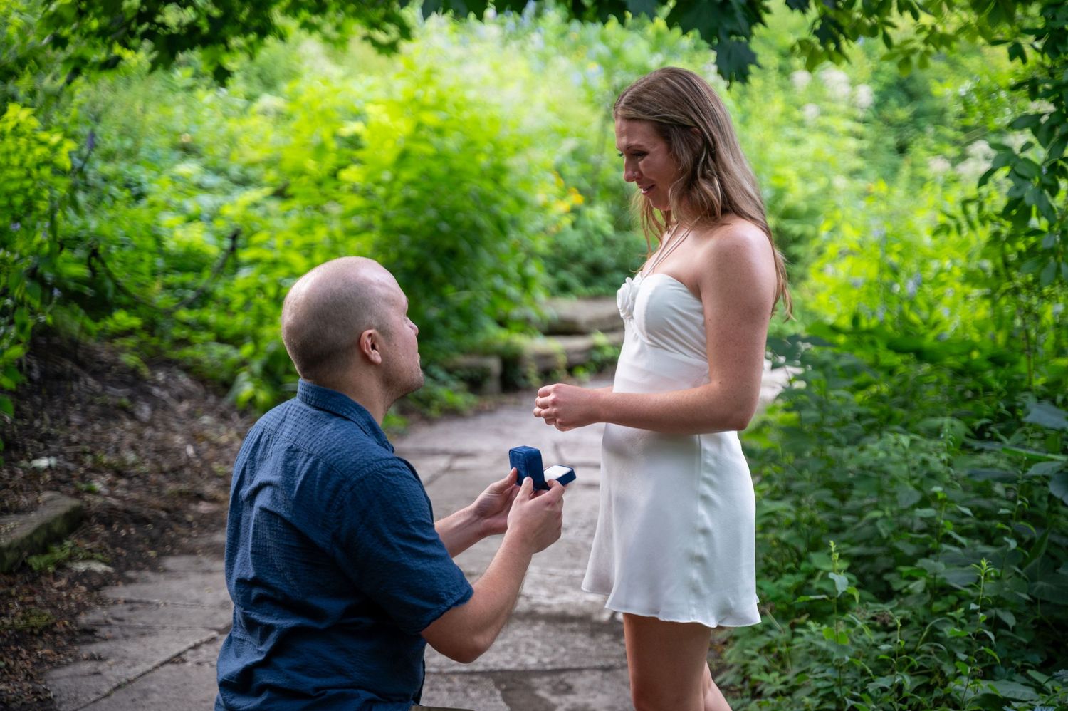 A sequence of photos showing a rooftop proposal moment with city skyline views in the background.