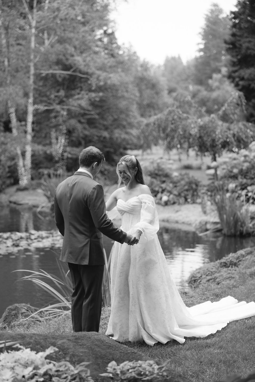 A series of wedding photographs in black and white showing newlyweds sharing intimate moments beside a tranquil pond.