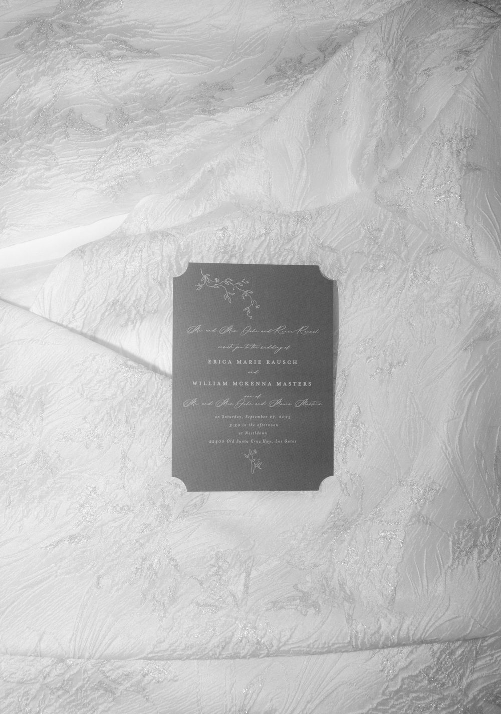 Business card design mockup on white textured paper showing minimalist typography layout in dark gray.