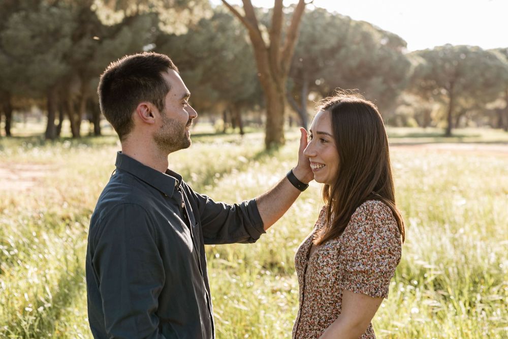 Couple walking with dog through pine forest during pre wedding photoshoot in Lagoa de Albufeira, Sesimbra Portugal