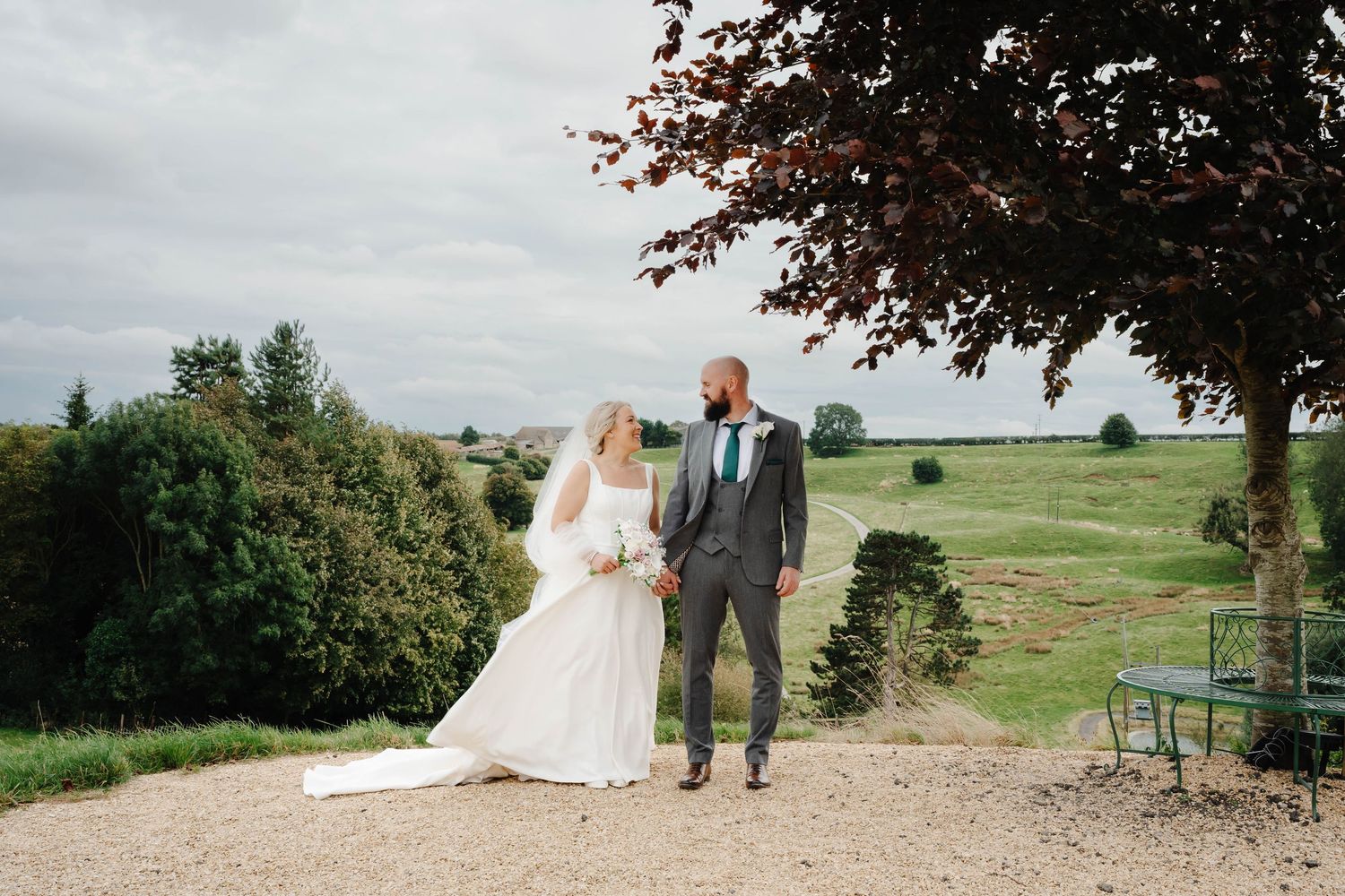 Cotswolds Wedding Photographer Zara Davis Photography Gloucestershire Kingscote Barn couple posing at the top of the hill