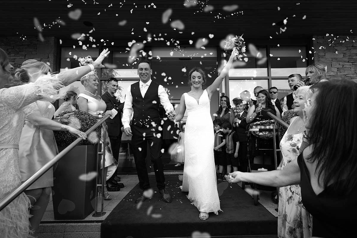Couples dancing together under twinkling lights at an evening wedding reception celebration.