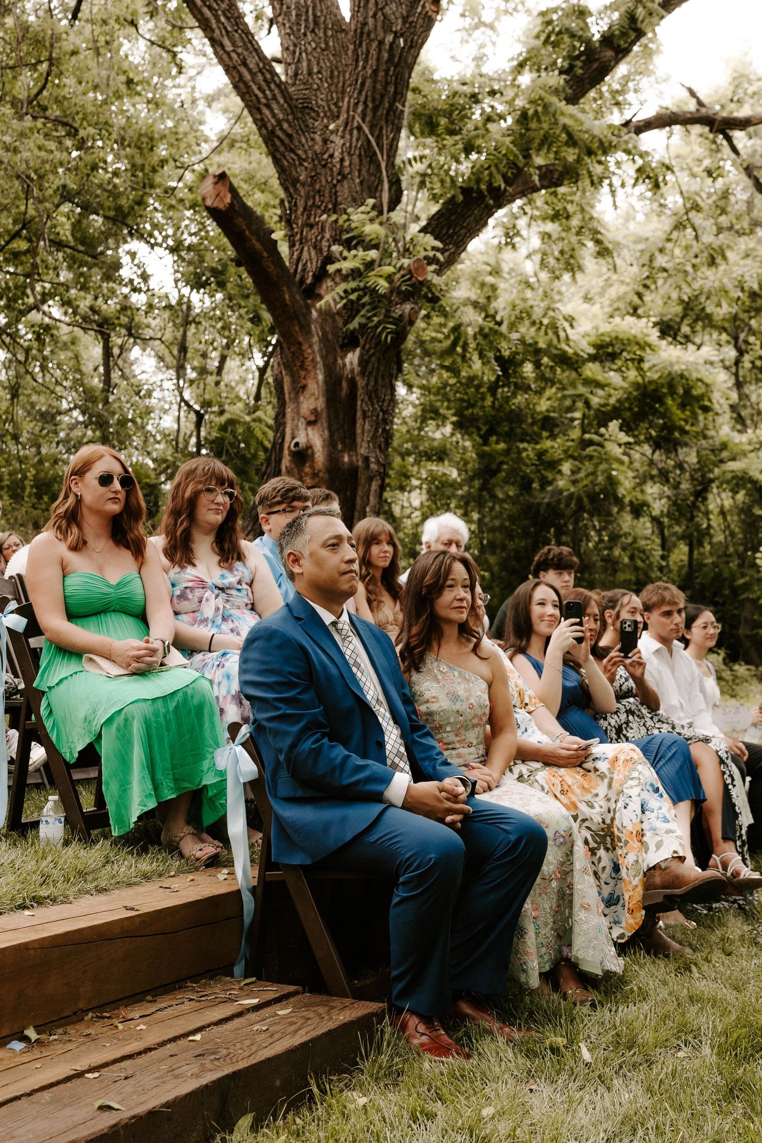 Black and white photo of wedding guests seated in church pews during ceremony.