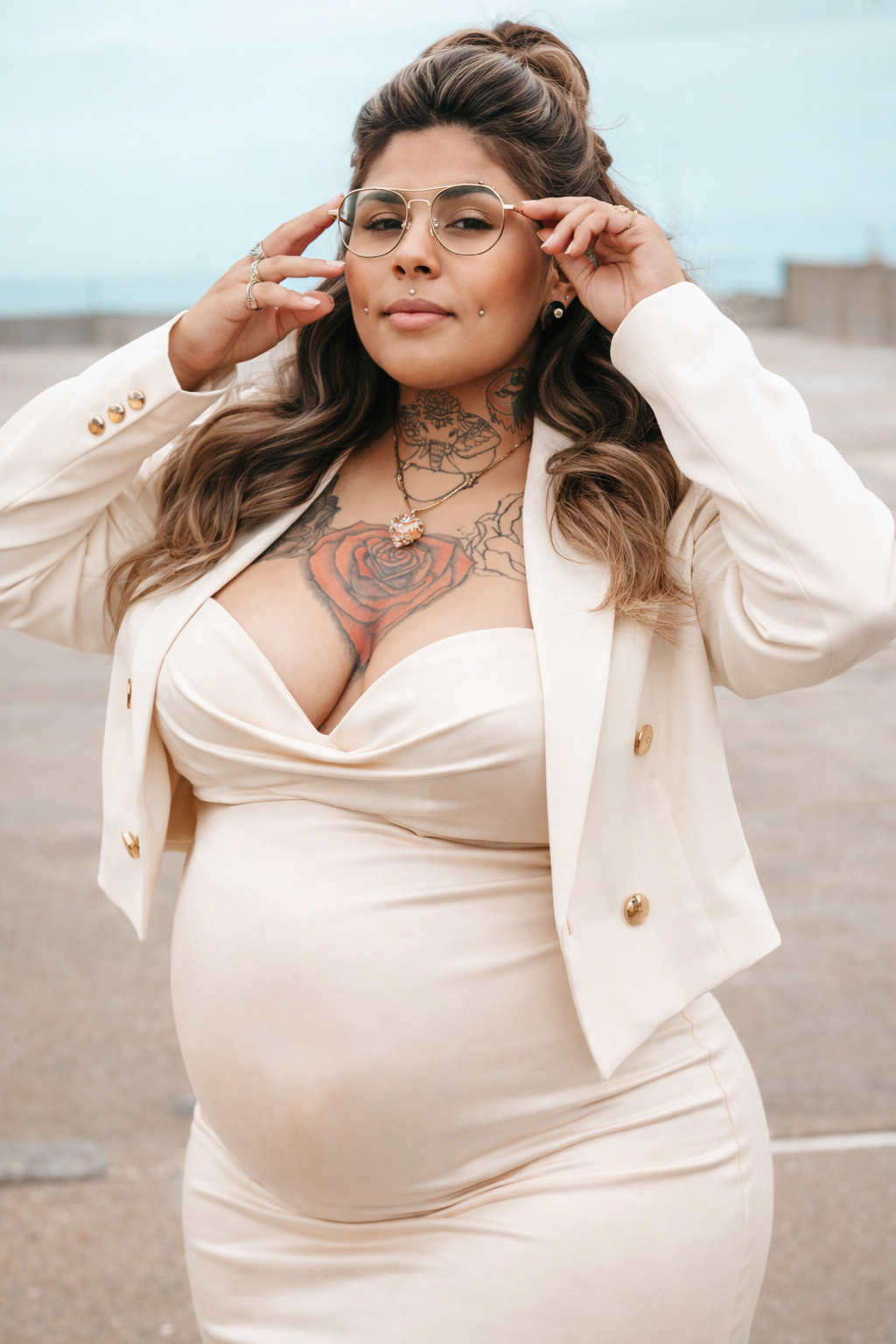 A person in a cream-colored outfit poses confidently against a light background in a fashion photoshoot series.