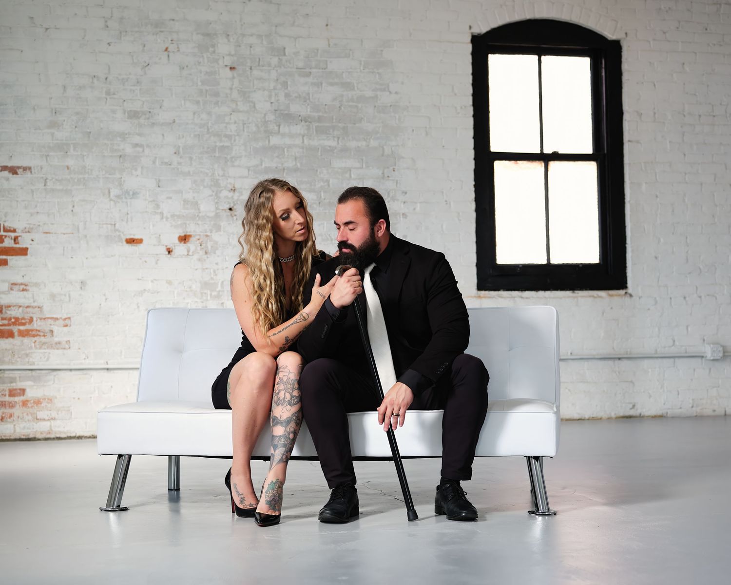David G Holt Photography - Artistic black and white photo sequence showing two people in intimate poses against a white brick wall.