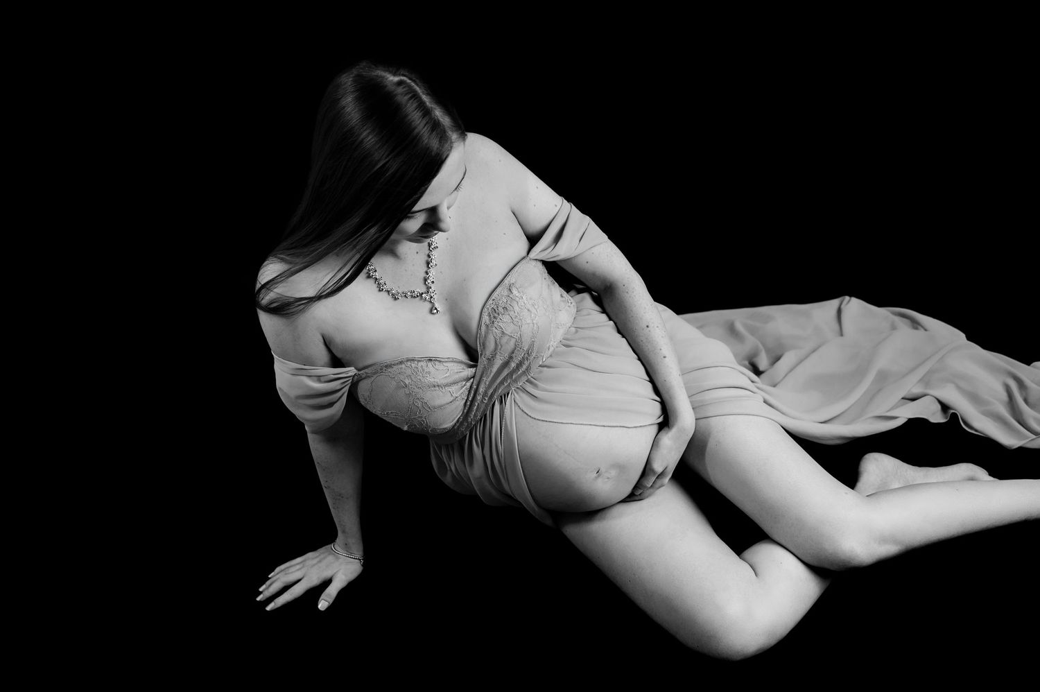 A series of black and white artistic nude photographs showing graceful poses and body forms in dramatic lighting.