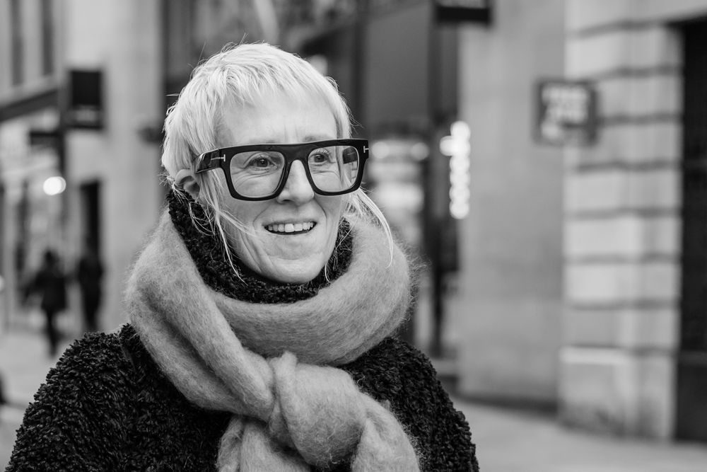 A black and white collage of people wearing winter hats and glasses smiling outdoors in an urban setting.