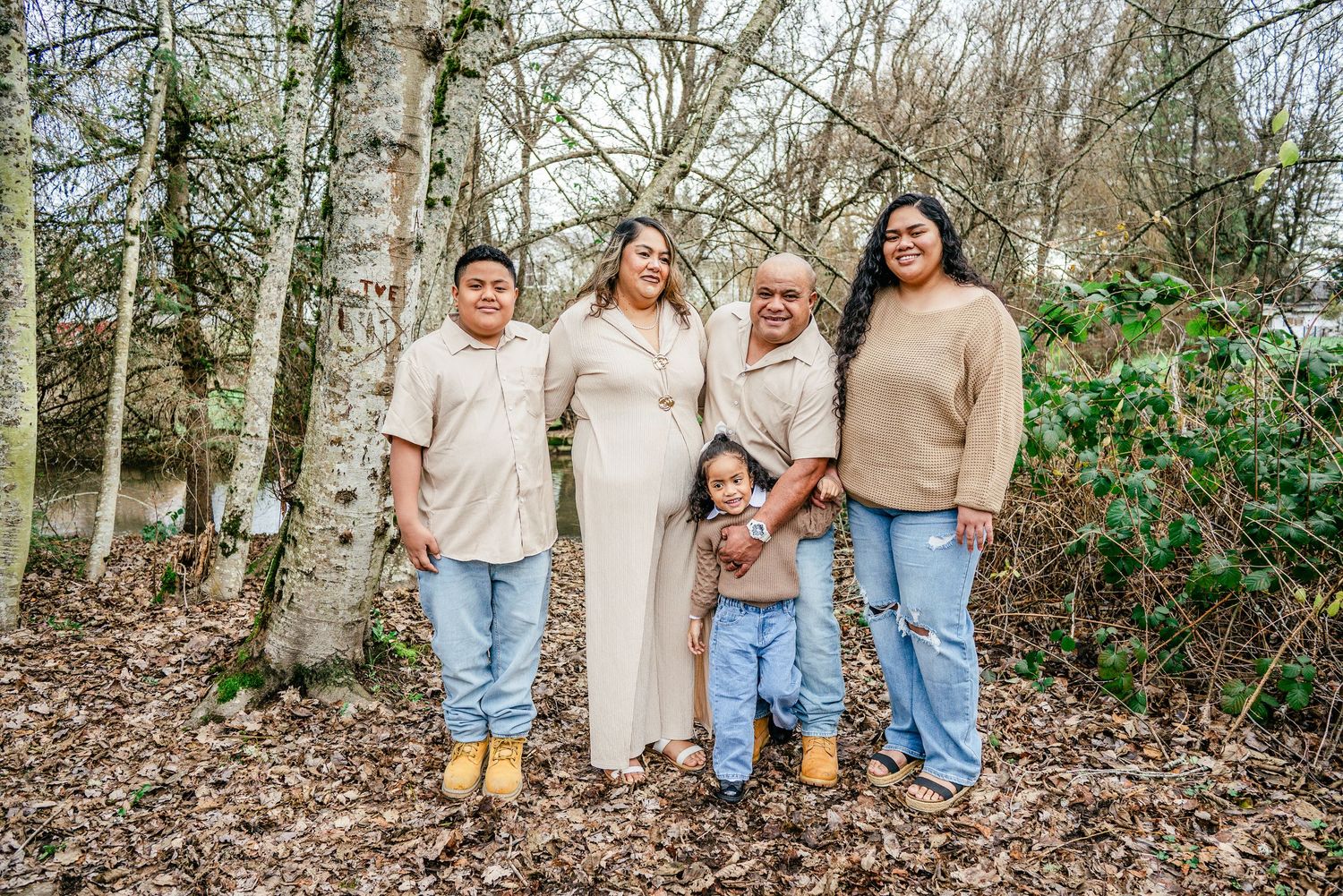 Relaxed family portrait of parents and three children at DeCoursey Park in Puyallup during January