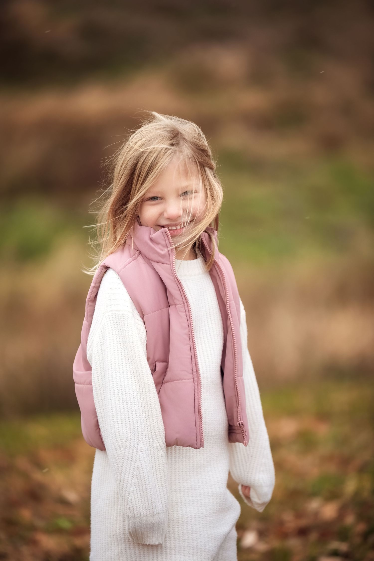 A series of candid photos showing someone in a white sweater and pink scarf enjoying a playful moment outdoors.