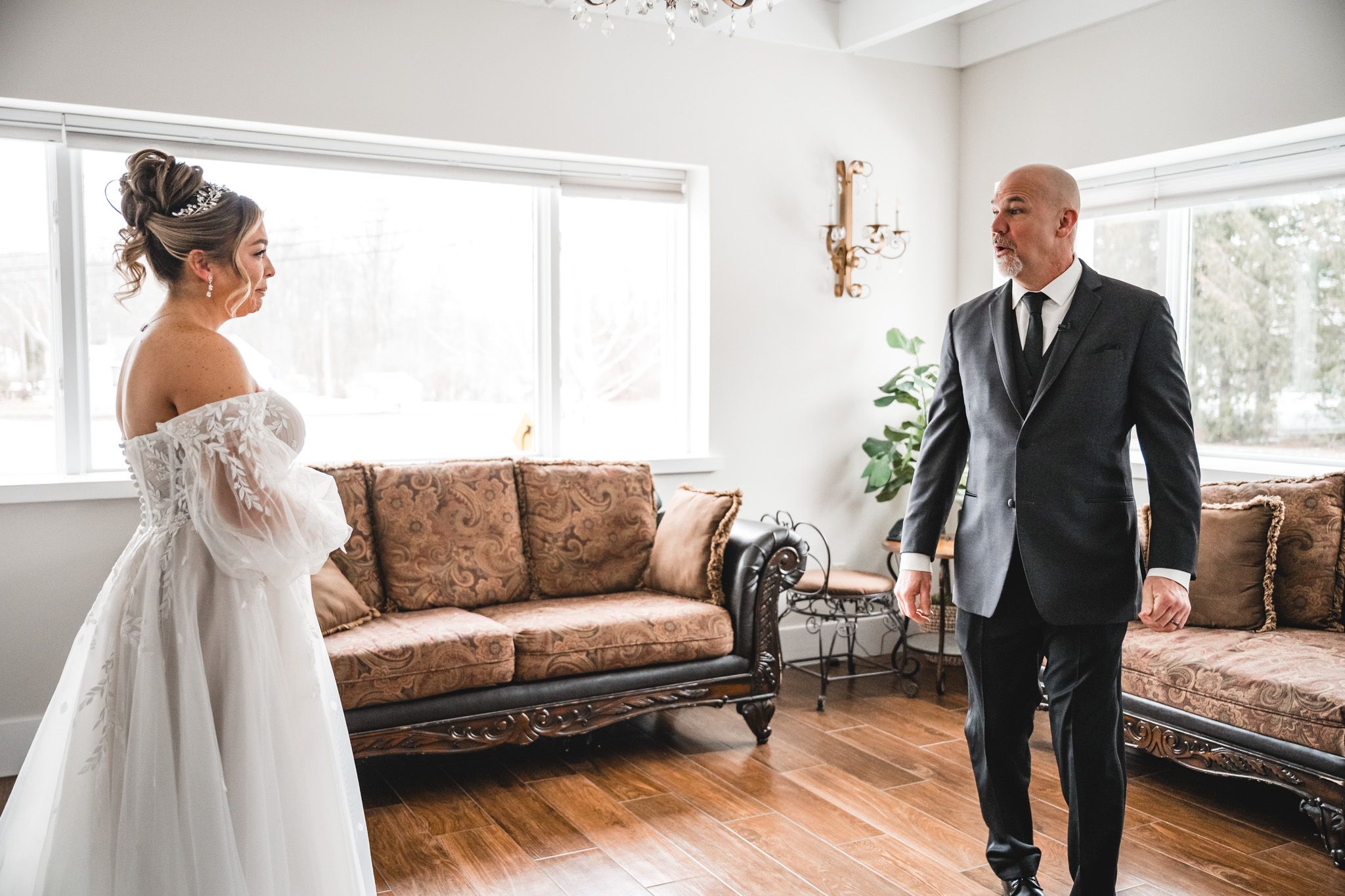 Elegant wedding venue interior with hardwood floors and vintage brown leather furniture.