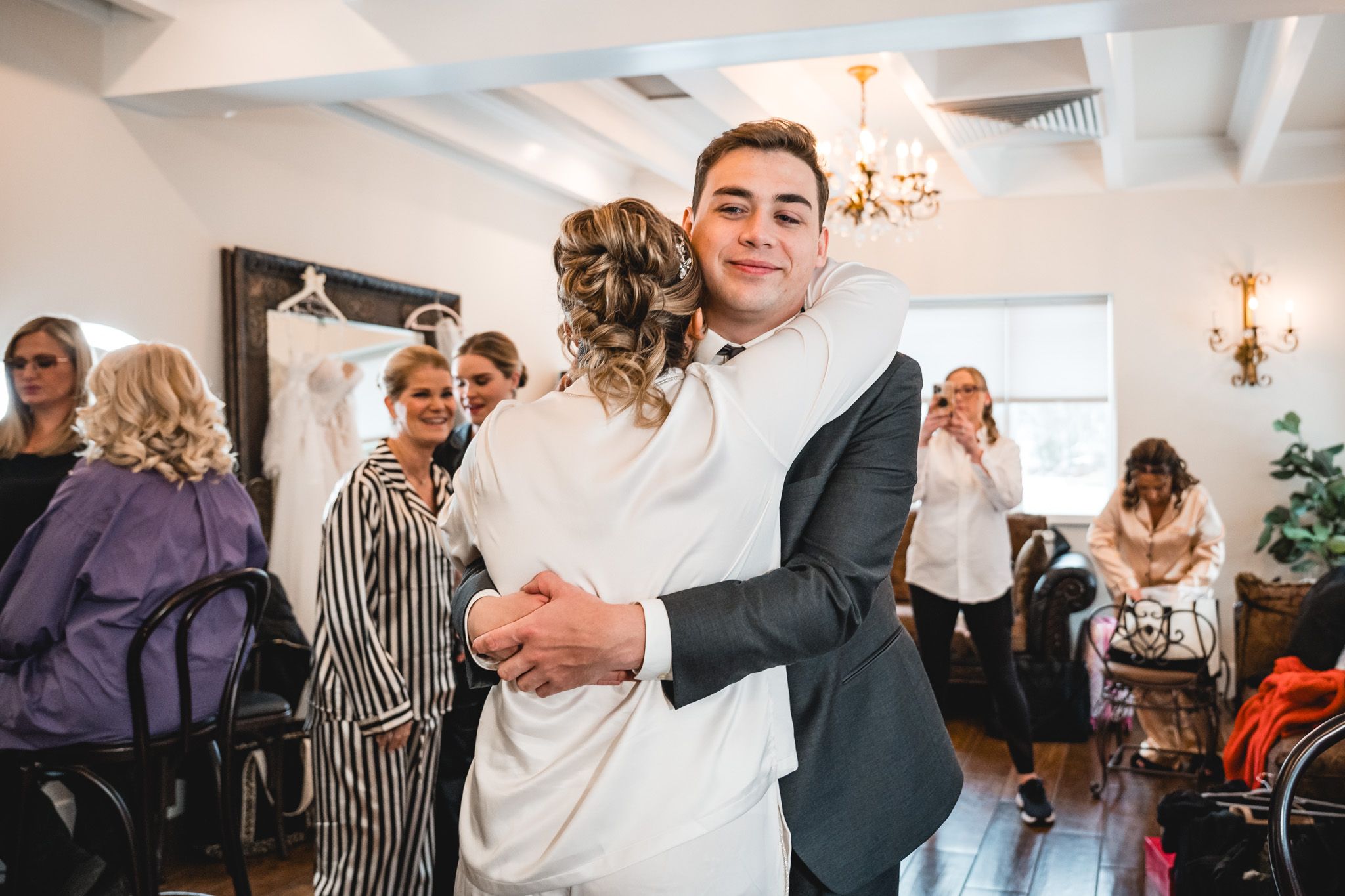 Wedding reception guests watching couple share their first dance.