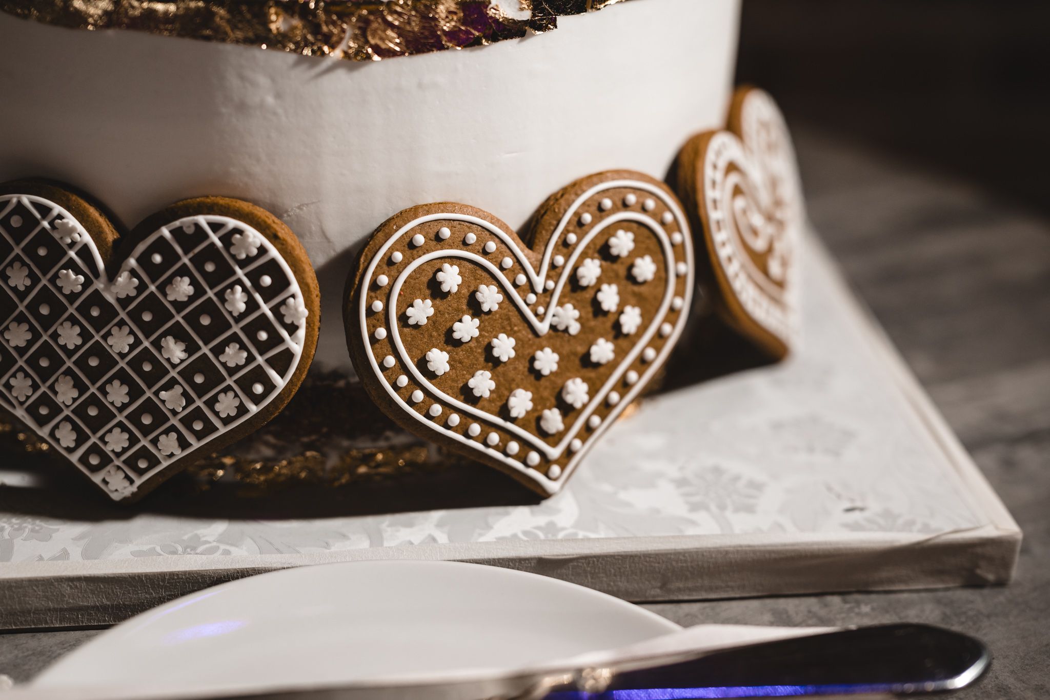 Close-up detail of ornate wedding decorations with intricate patterns and metallic finishes.