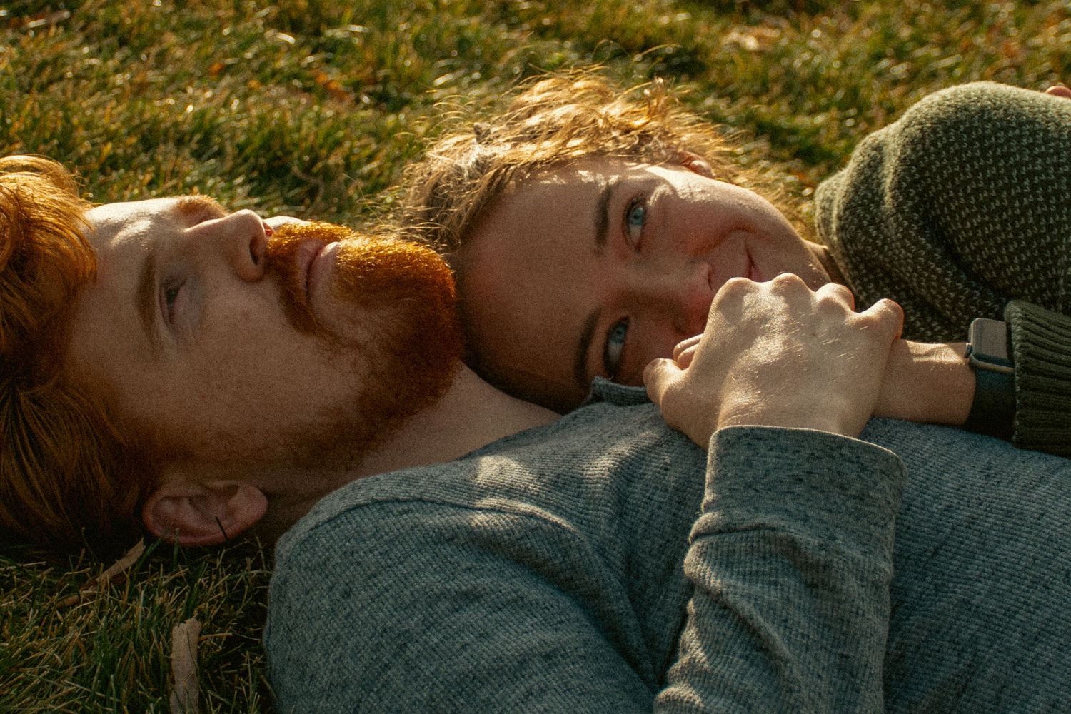 A sequence of intimate couple portraits lying together in grass during golden hour sunlight.
