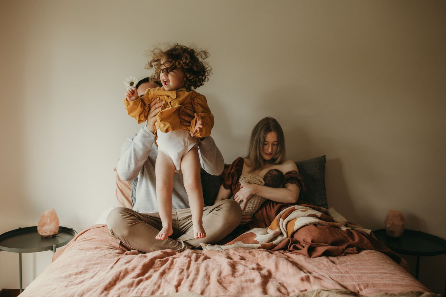 Toddler girl jumping on the bed at home in Melbourne