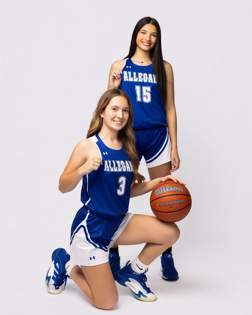 Basketball player in blue Allseal uniform poses in three different positions with ball against white backdrop.
