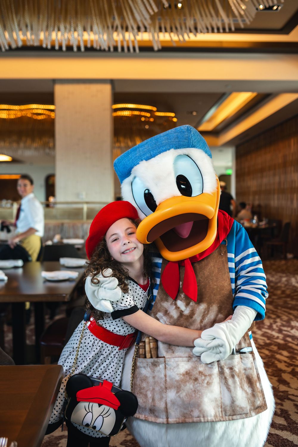 A series of photos showing playful interactions with Donald Duck character at a Disney dining experience.