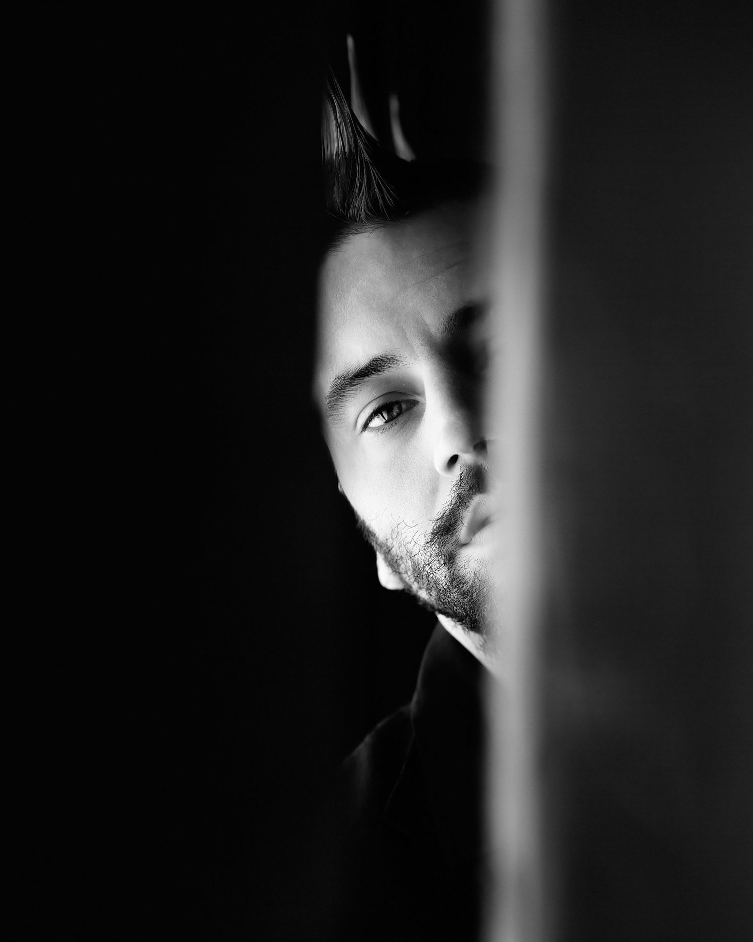 David G Holt Photography - Dramatic black and white portrait with light and shadow creating a mysterious silhouette effect.