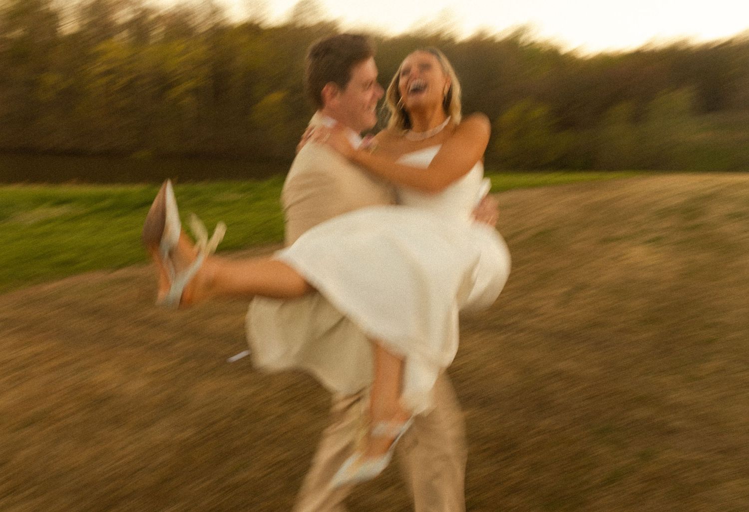 A romantic spin captured in motion blur during a sunset wedding photoshoot.