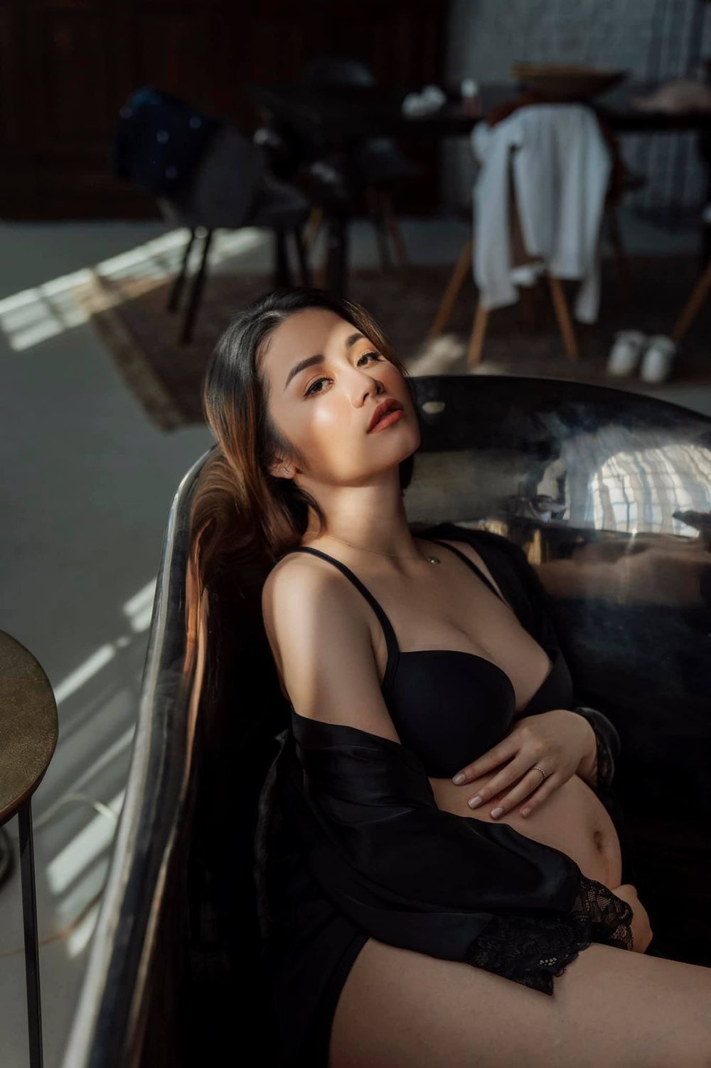 Artistic boudoir photo with dramatic lighting and shadow play.