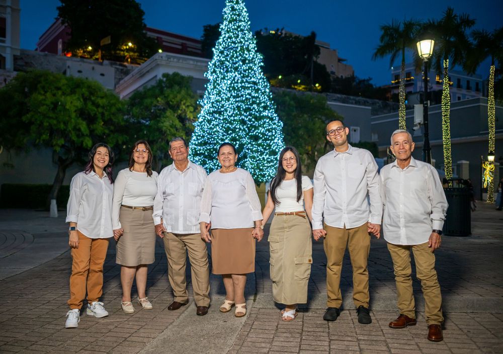 A group scene at sunset with matching beige and brown outfits against a twilight backdrop.