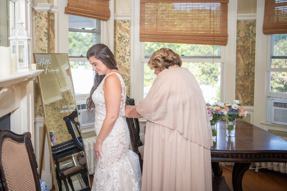 Wedding preparation scene in a sunlit room with bamboo window shades.