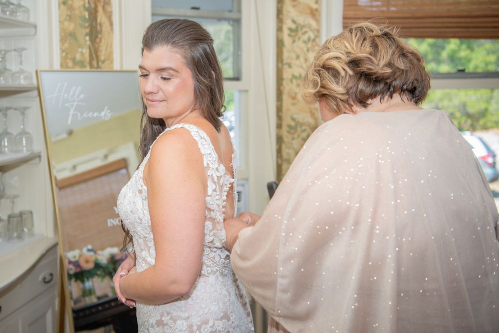 Wedding dress fitting moment captured in a naturally lit room.