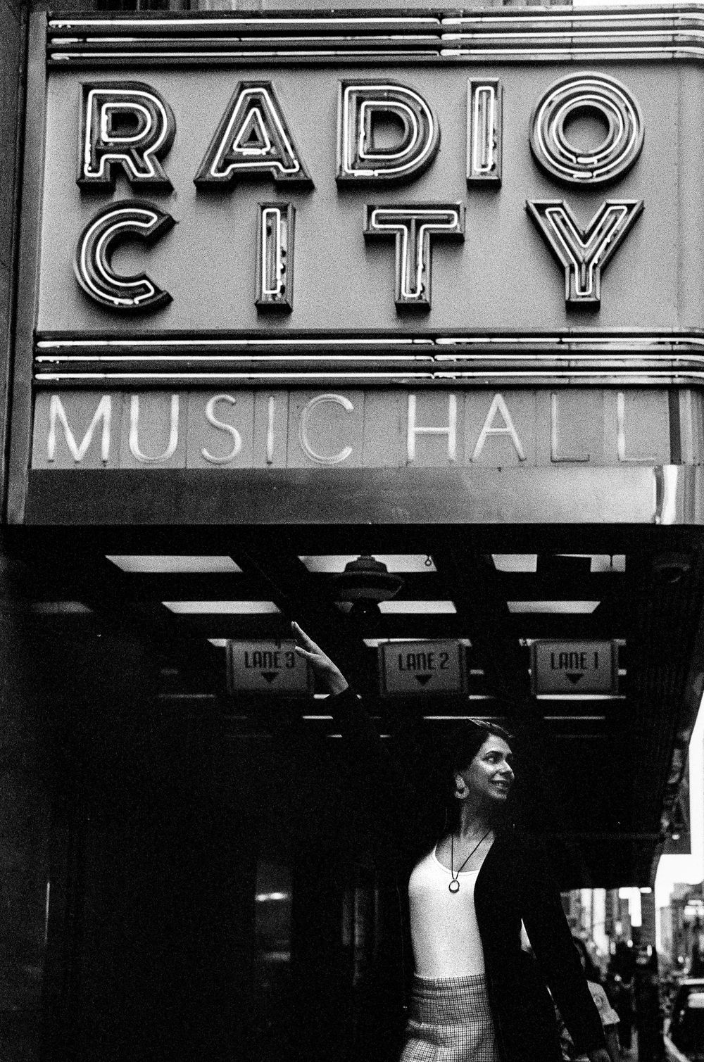 Classic Radio City Music Hall neon sign entrance in black and white.