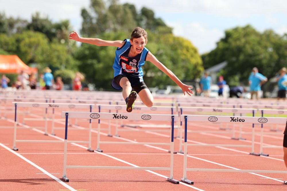Focal Point Images
Track athlete jumping over hurdles during competition on outdoor running track.