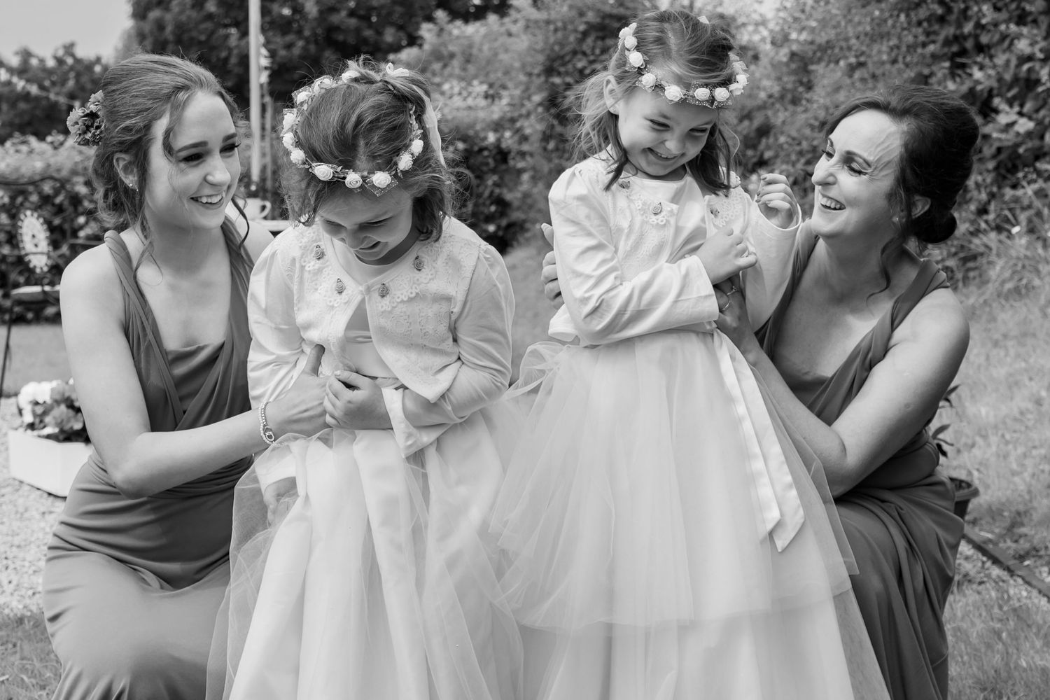 Black and white wedding photography capturing joyful moments with guests.