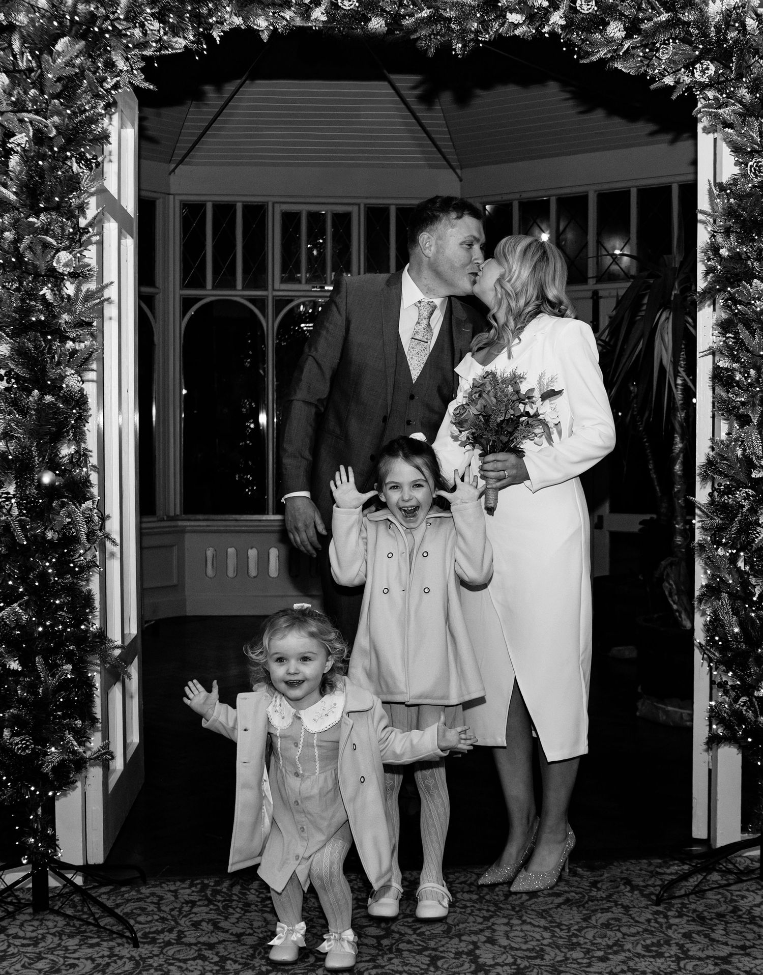 Black and white photos of children in formal attire at a wedding celebration.