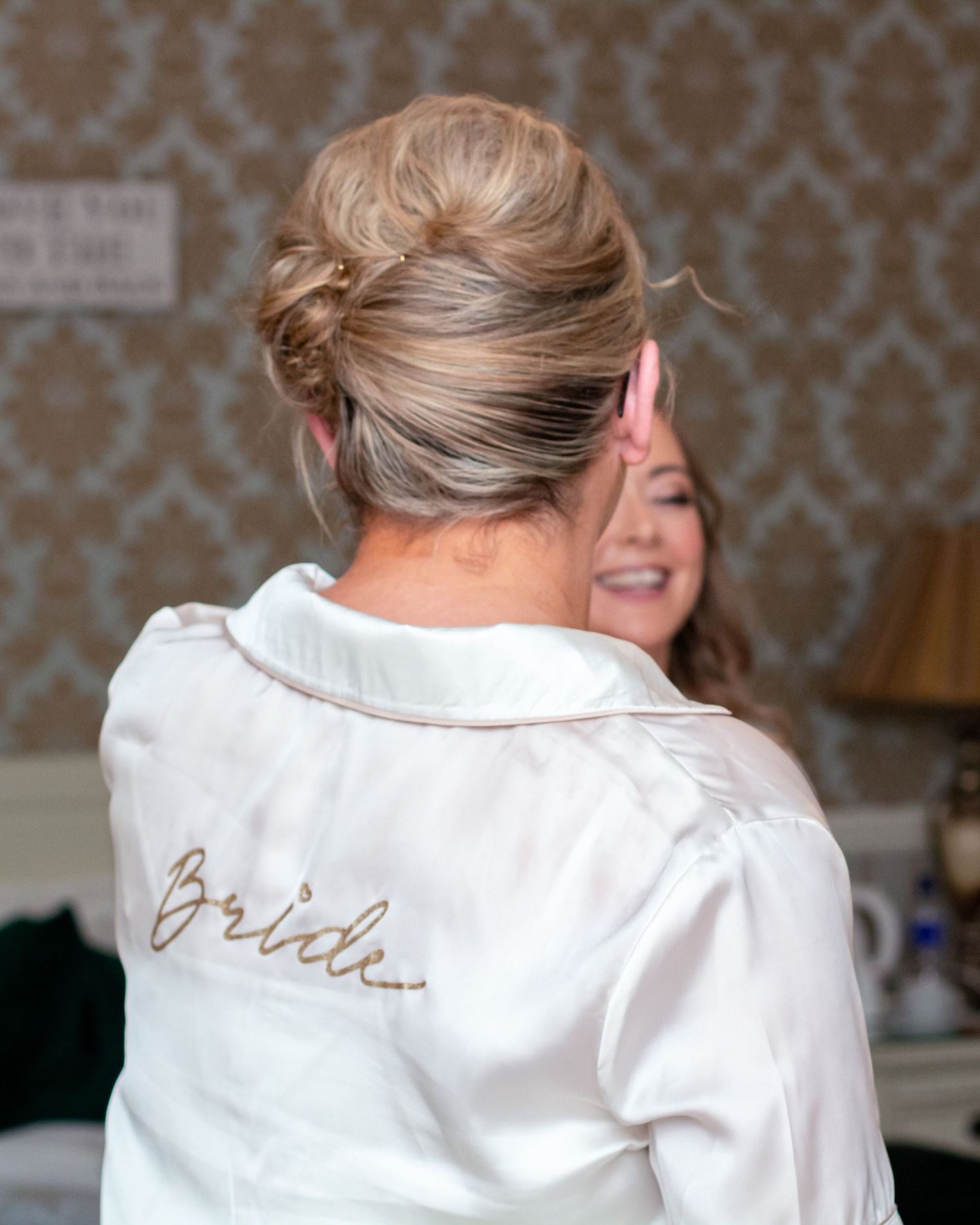 White satin robe with 'Bride' embroidery detail shown from different angles.